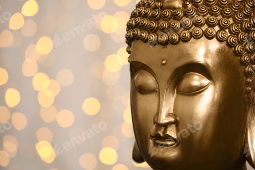 Preview: Buddha statue against blurred lights, closeup. Space for text