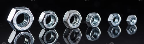 Preview: panoramic shot of shiny metallic nuts row isolated on black