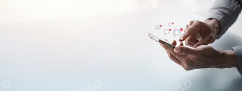 Preview: A person holding a smartphone with a popup application icon.