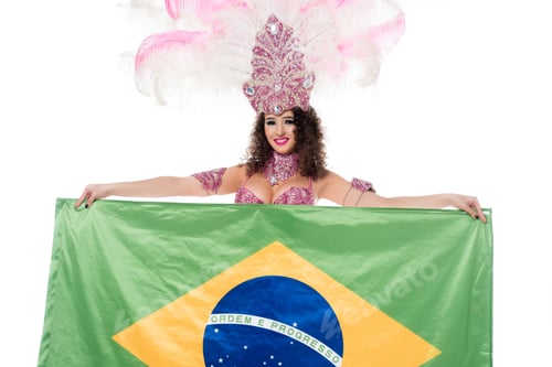 Preview: Cheerful woman in carnival costume with pink feathers holds flag of Brasil isolated on white