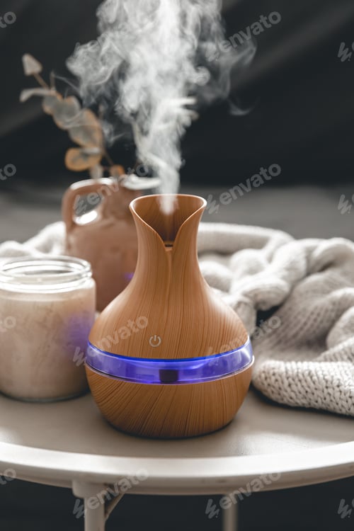 Preview: Spa composition with aroma oil diffuser lamp and candle on a blurred background.