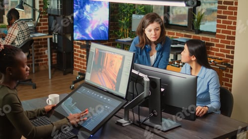 Preview: Creative people analyzing machine industry software on computer