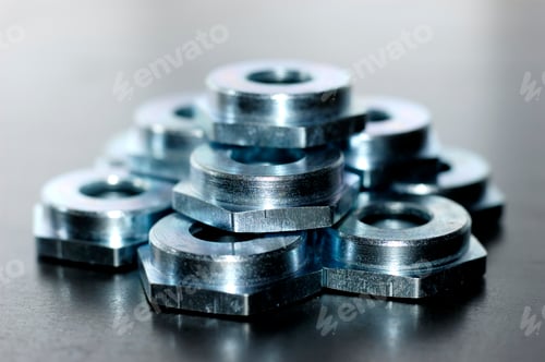 Preview: Close-up of several flat metal nuts
