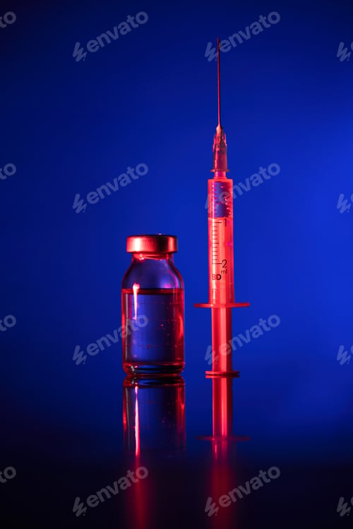 Preview: Vial and syringe with vaccine in dark room
