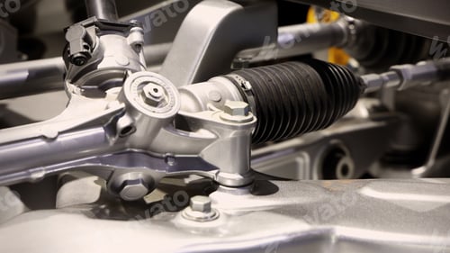 Preview: Car suspensions. Close up of a car suspension parts system such as CV joint Rubber boot and Control arms bushing Steering rack axles Shock absorber suspension Brake. Repair and spare parts for cars.