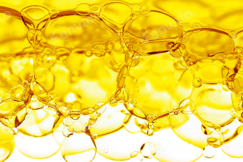 Preview: Transparent yellow bubbles in liquid. Cosmetic essence, serum