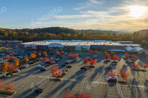 Preview: Aerial view of large parking lot in front of rgocery store with many parked colorful cars