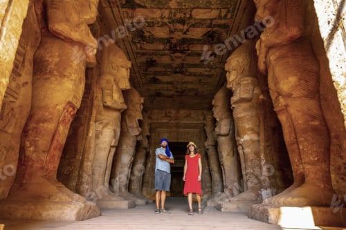 Preview: A tourist couple at the Abu Simbel Temple next to the sculptures, in southern Egypt
