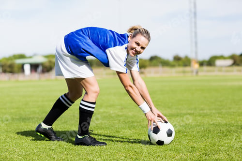 Preview: Portrait of female football player keeping a ball