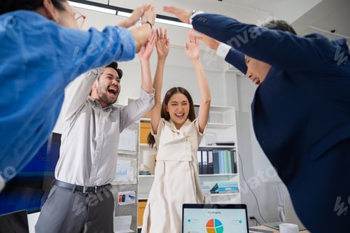 Preview: Asian business people stack hands in modern office showing unity and teamwork