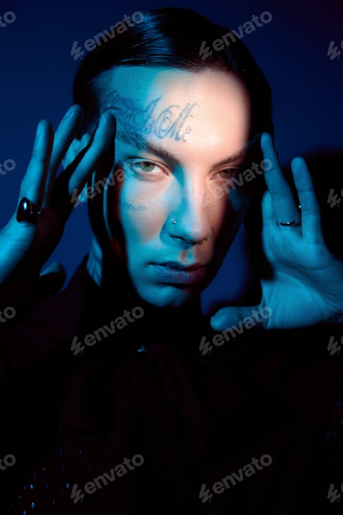 Preview: Handsome young man showcases striking style in captivating artistic lighting