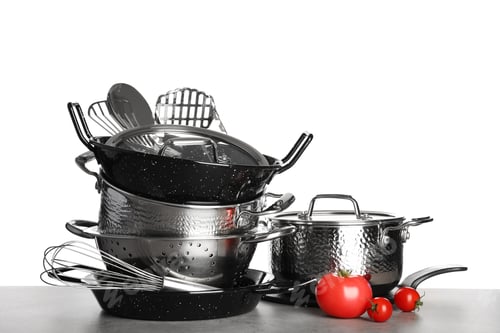 Preview: Set of clean cookware, utensils and vegetables on table against white background