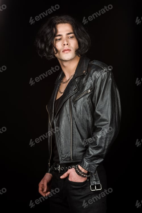 Preview: handsome man standing with hand in pocket isolated on black