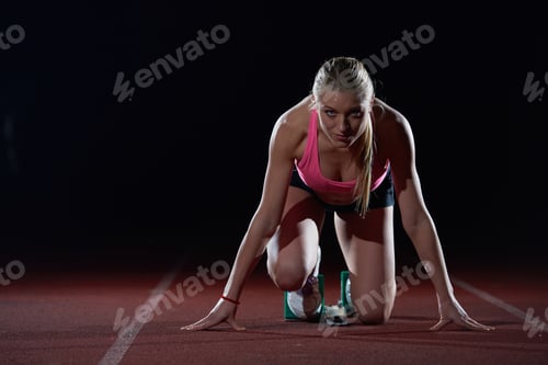 Preview: Woman Sprinter Leaving Starting Blocks On The Athletic Track. Side View. Exploding Start
