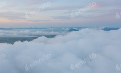 Preview: Aerial view of sunrise above fluffy sea fog misty clouds with mountain hill. Nature landscape