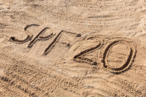 Preview: Sun protect factor twenty concept. SPF 20 word written on the beach