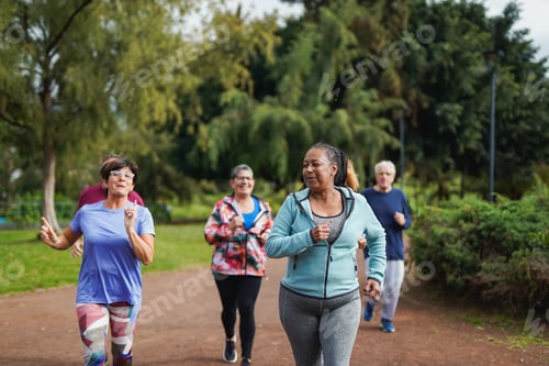 Preview: Group of multiracial senior friends running at city park - Fit elderly people having fun doing sport
