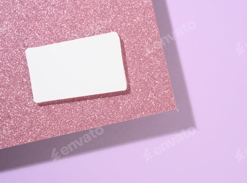 Preview: Blank rectangular business card lies on a modern purple background sheets of paper with a shadow
