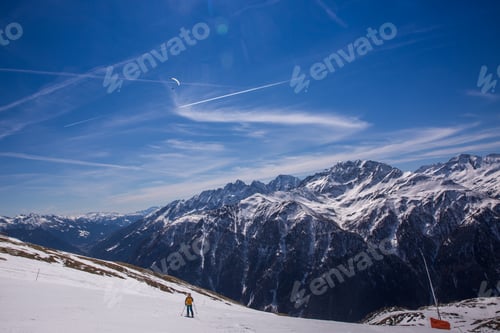 Preview: Paragliding over Alps with mountain cliffs covered with snow in Karnten Austria