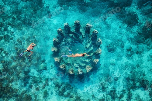 Preview: The couple snorkeling near the famous place on Gili Meno Island, Indonesia. Aerial view from drone.