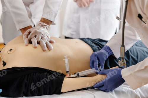 Preview: Doctors practicing cardiopulmonary resuscitation and intravenous injection on medical manikin
