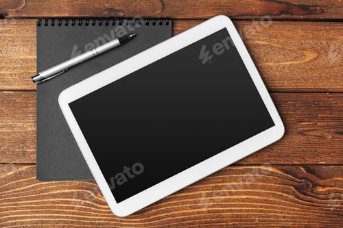 Preview: Tablet with notepad on wooden background