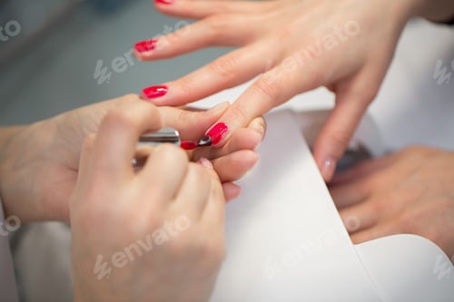 Preview: Red Nail Polish Being Applied in Salon