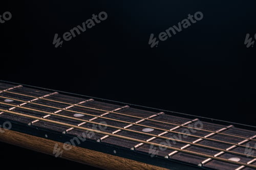 Preview: Close-up of an acoustic guitar fretboard copy space.