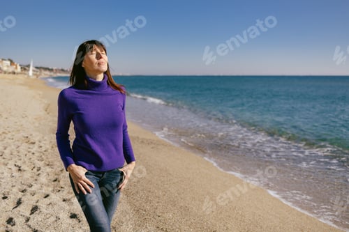 Preview: Beautiful woman happy and relaxed on the beach