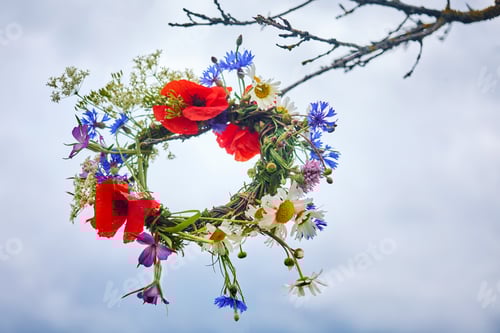 Preview: Summer Solstice Day, Midsummer. pagan witch traditions. Colorful Floral Wreath Suspended in the Sky