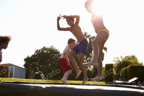 Preview: Group Of Children Having Fun Jumping On Outdoor Trampoline