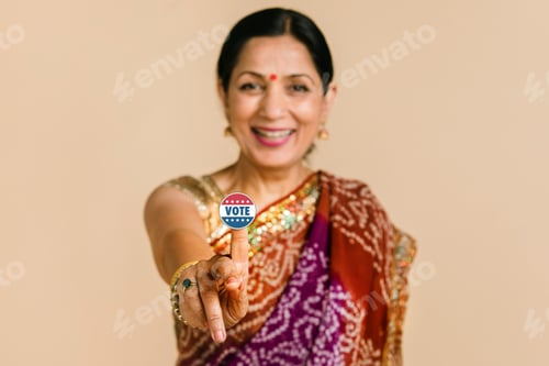 Preview: Indian woman showing a vote sticker