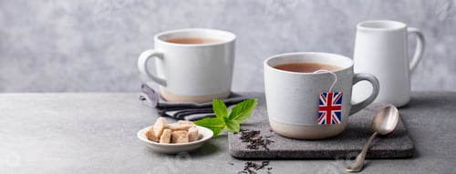 Preview: Tea in Mugs with British Flag Tea Bag Label. Grey Background. Copy Space.