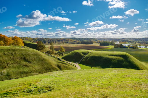 Preview: Tranquil autumn scene in Kernave, Lithuania, with hills and a narrow path on a beautiful autumn day