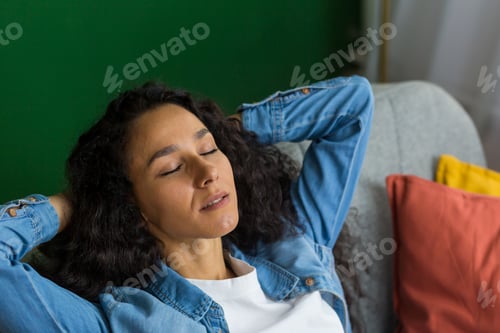 Preview: A businesswoman, freelancer Hispanic woman resting at home after work, closed her eyes, relaxed.