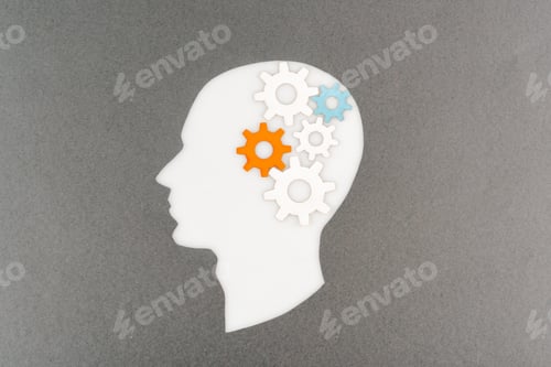 Preview: top view of cut out white human head with colorful gears isolated on grey