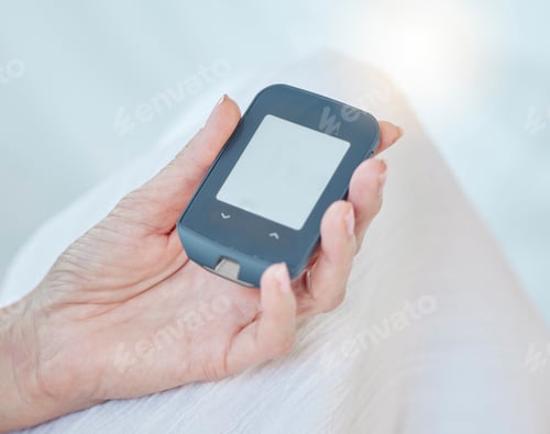 Preview: Closeup of a senior diabetic woman checking her blood sugar glucose levels with a diabetes reading