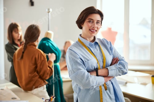 Preview: Confident woman dressmaker standing with crossed arms