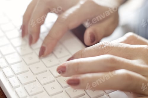Preview: Close-up view woman hands typing on white keyboard