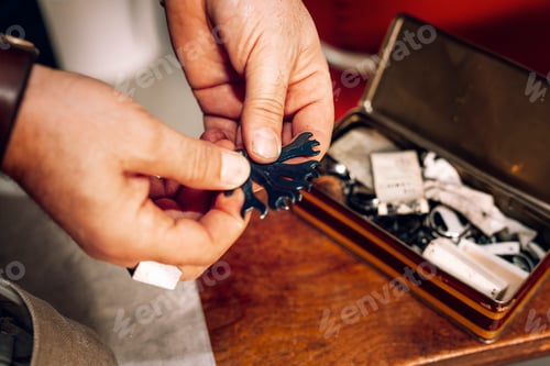 Preview: Craftsperson inspecting a delicate piece at a workbench