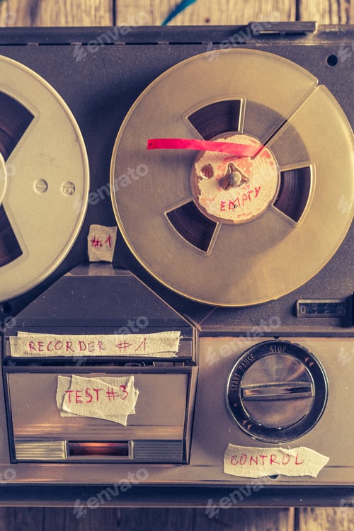 Preview: Old audio tape recorder and a used rolls of tape.