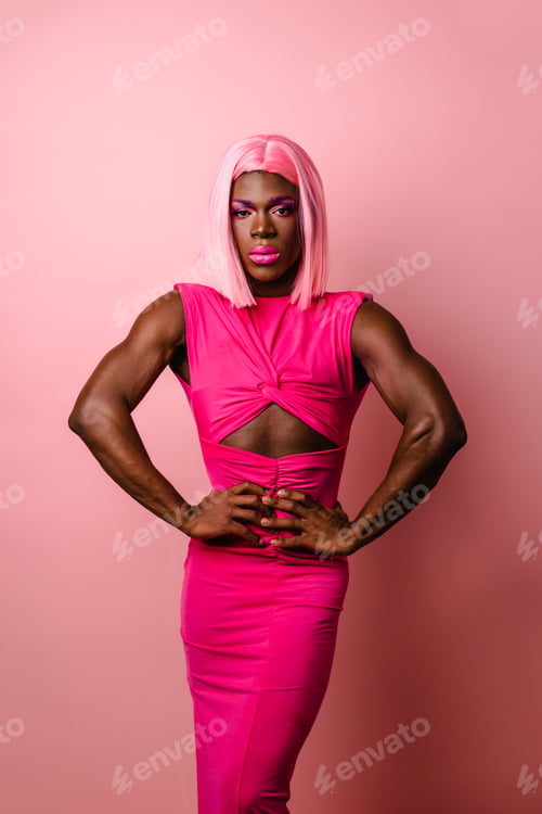 Preview: African transgender person looking at the camera while posing against an isolated background.