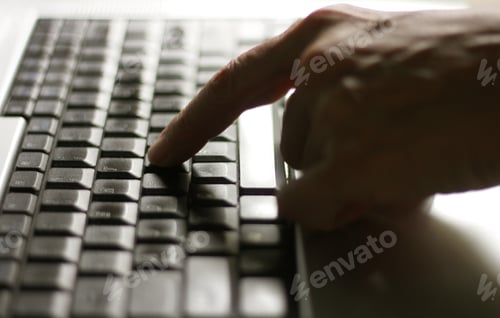 Preview: Using laptop, hands typing on the laptop keyboard