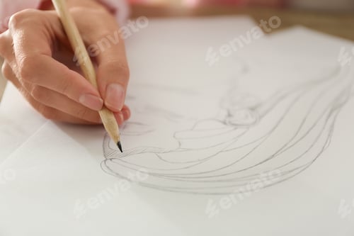 Preview: Woman drawing girl's portrait with pencil on sheet of paper, closeup
