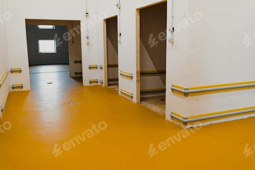 Preview: New polished concrete floor covered with a layer of yellow epoxy resin