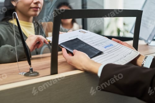Preview: Young Adult Woman Submitting Passport and Documents at Visa Center Counter