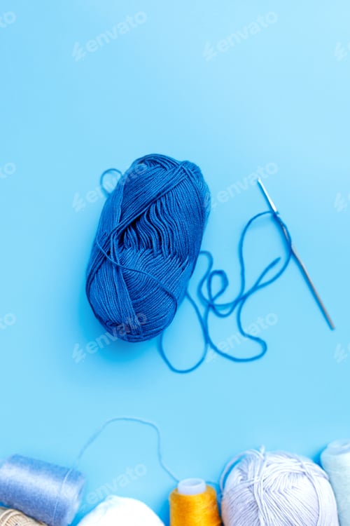 Preview: Blue Yarn Ball with Crochet Hook on Blue