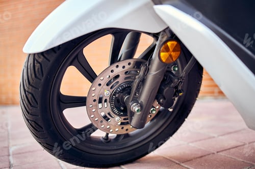 Preview: Closeup of a motorcycle wheel in the foreground