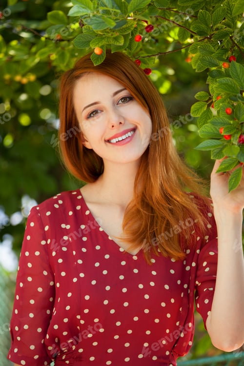 Preview: Redhead girl near cherry