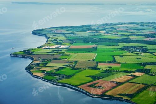Preview: Aerial view of coastline with green farmlands and Baltic sea in Denmark